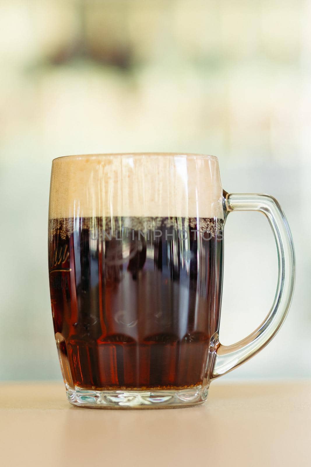 Photo of glass beer cup standing on smooth wooden surface. by StudioLucky