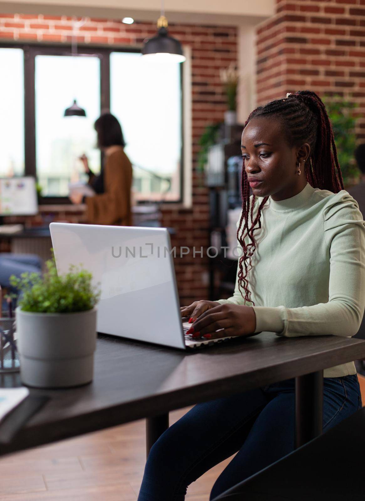 Businesswoman analyzing company turnover typing marketing strategy on laptop computer working in startup office. Executive manager brainstorming ideas planning business collaboration