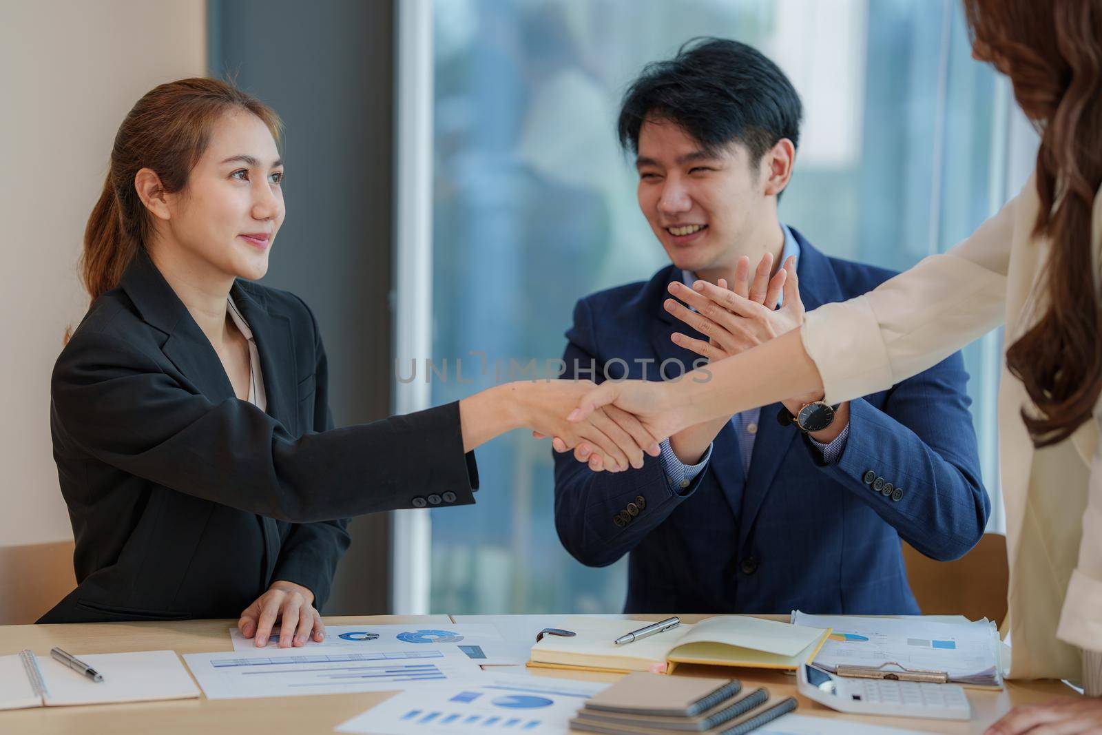 Business people successful negotiation and handshake. celebration partnership and teamwork, business deal concept. by itchaznong