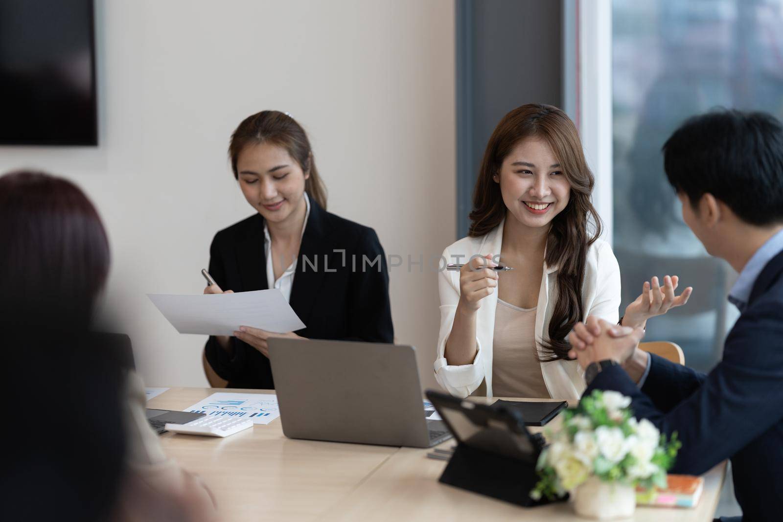 Group of Asian Business people discuss and brainstorming to analyze and plan about new financial project