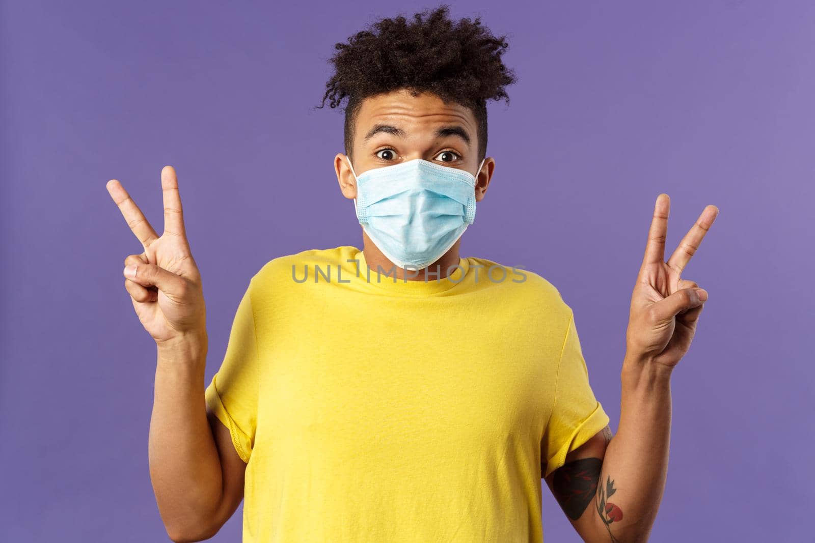 Medicine, covid19, coronavirus and people concept. Upbeat, hispanic man with afro haircut, wear medical face mask and show peace signs, staying positive, talking video-call while social distancing by Benzoix
