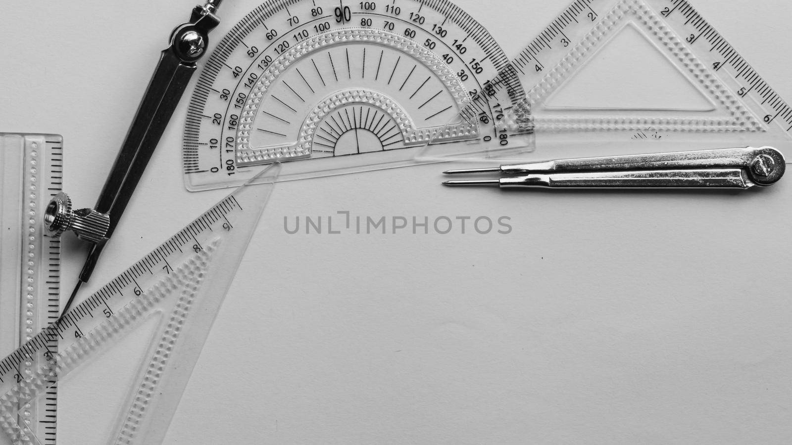 Geometric Measuring tools, Drawing items and mathematical instruments placed on white paper sheet. Back to school and Engineering education learning background. Empty Copy space room for text. by sudiptabhowmick