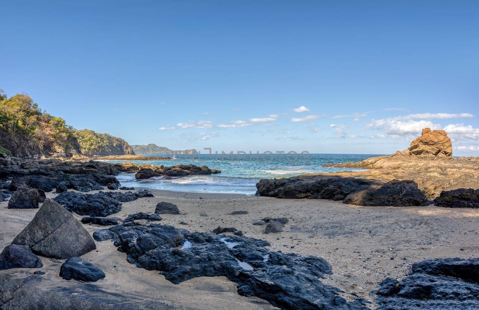 Playa Ocotal and Pacific ocean waves on rocky shore, El Coco Costa Rica by artush