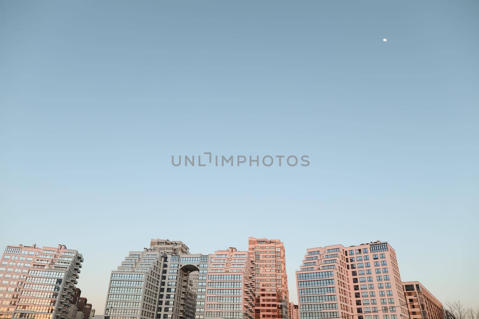 The urban landscape of large city. Exteriors of typical modern apartment buildings against a blue sky with clouds