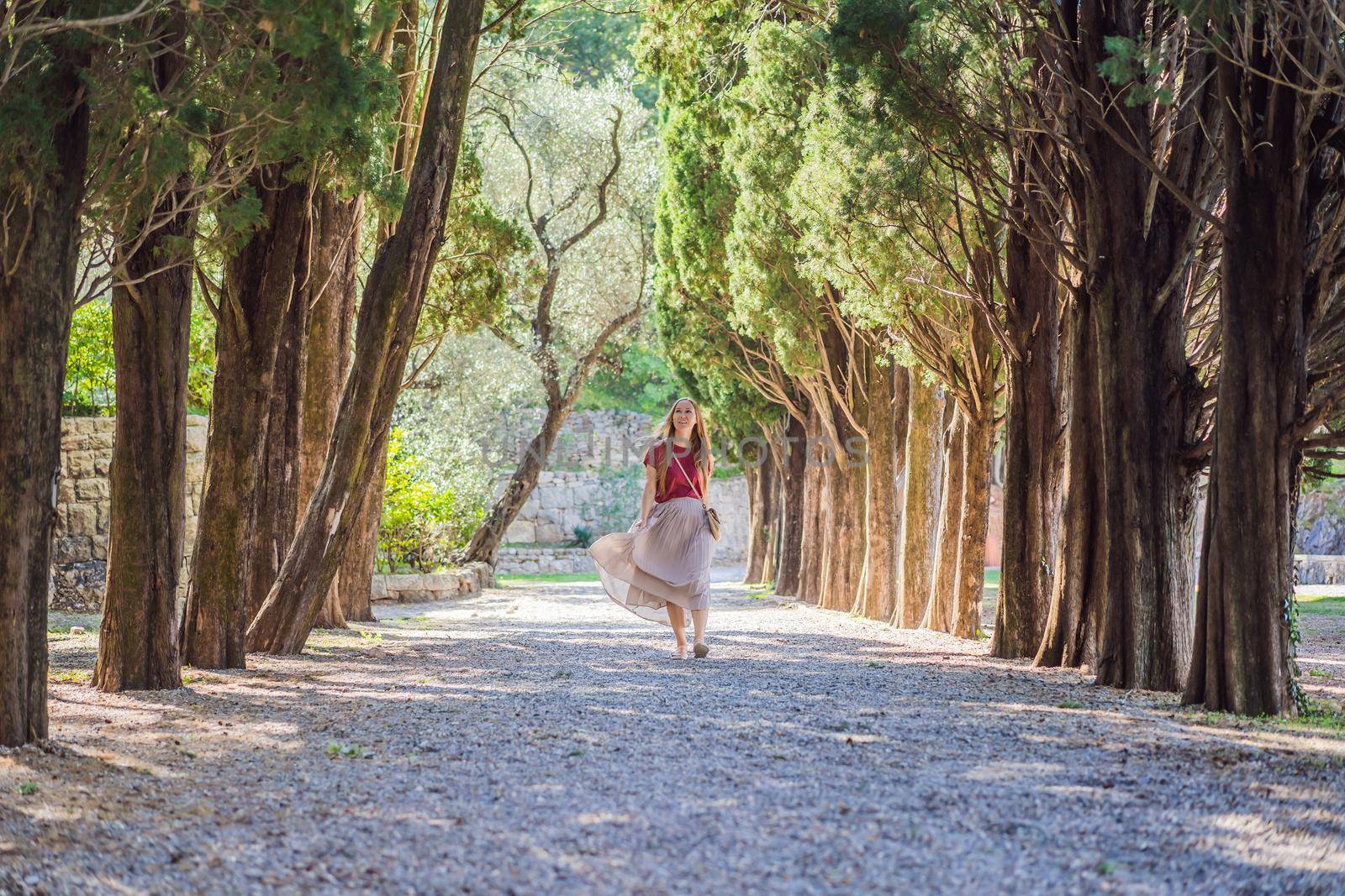 Woman tourist walking together in Montenegro. Panoramic summer landscape of the beautiful green Royal park Milocer on the shore of the the Adriatic Sea, Montenegro.