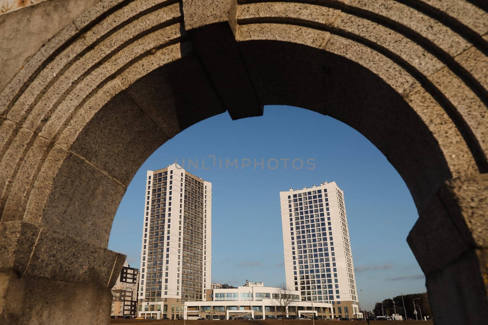The urban landscape of large city. Exteriors of typical modern apartment buildings against a blue sky with clouds