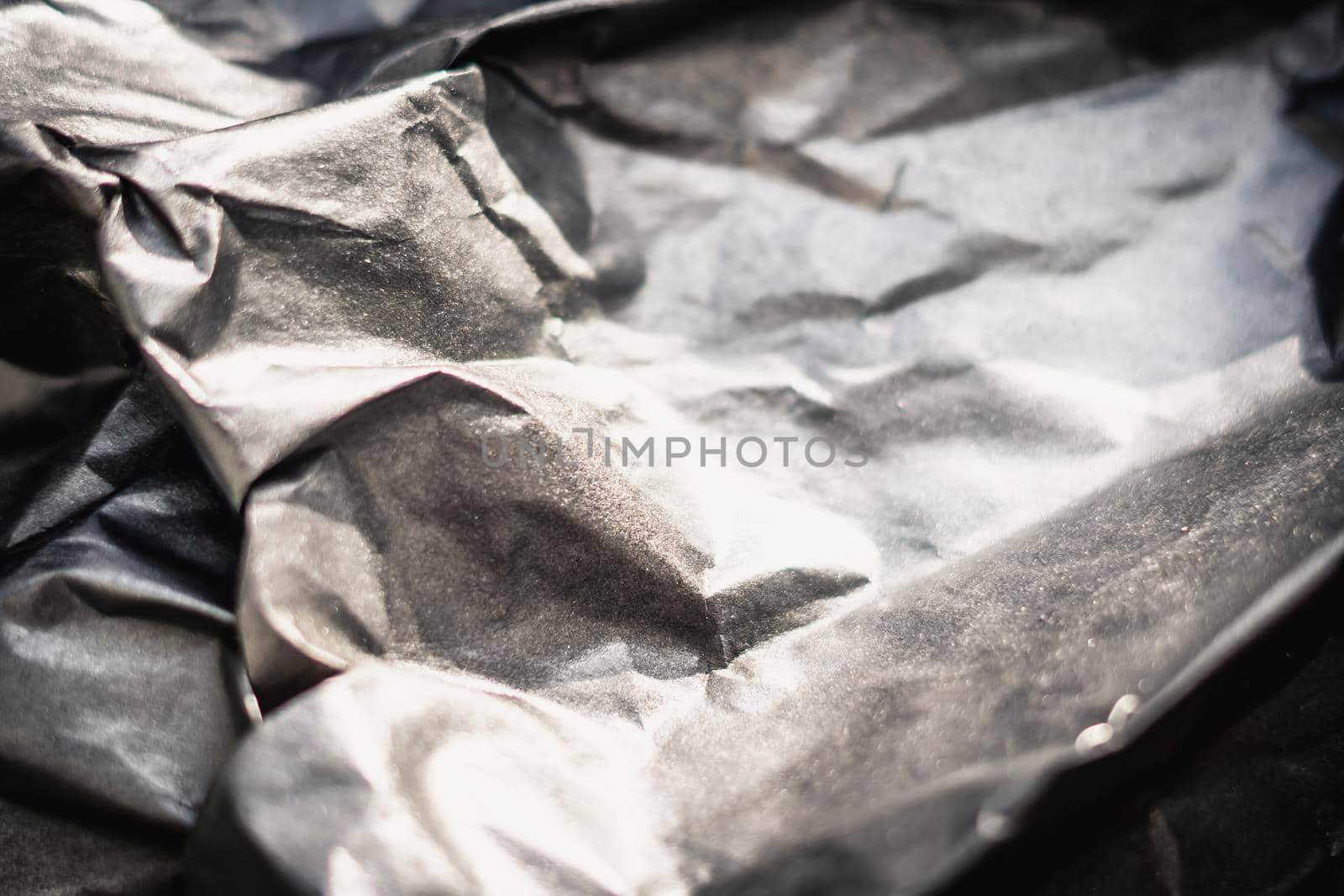 Abstract real paper surface background. Aluminum Platinum Silver foil. Wrinkled crumpled folds bend crush crease kink. Crystal, polygonal texture wave futurism 80s retro style new year. Brown tone.