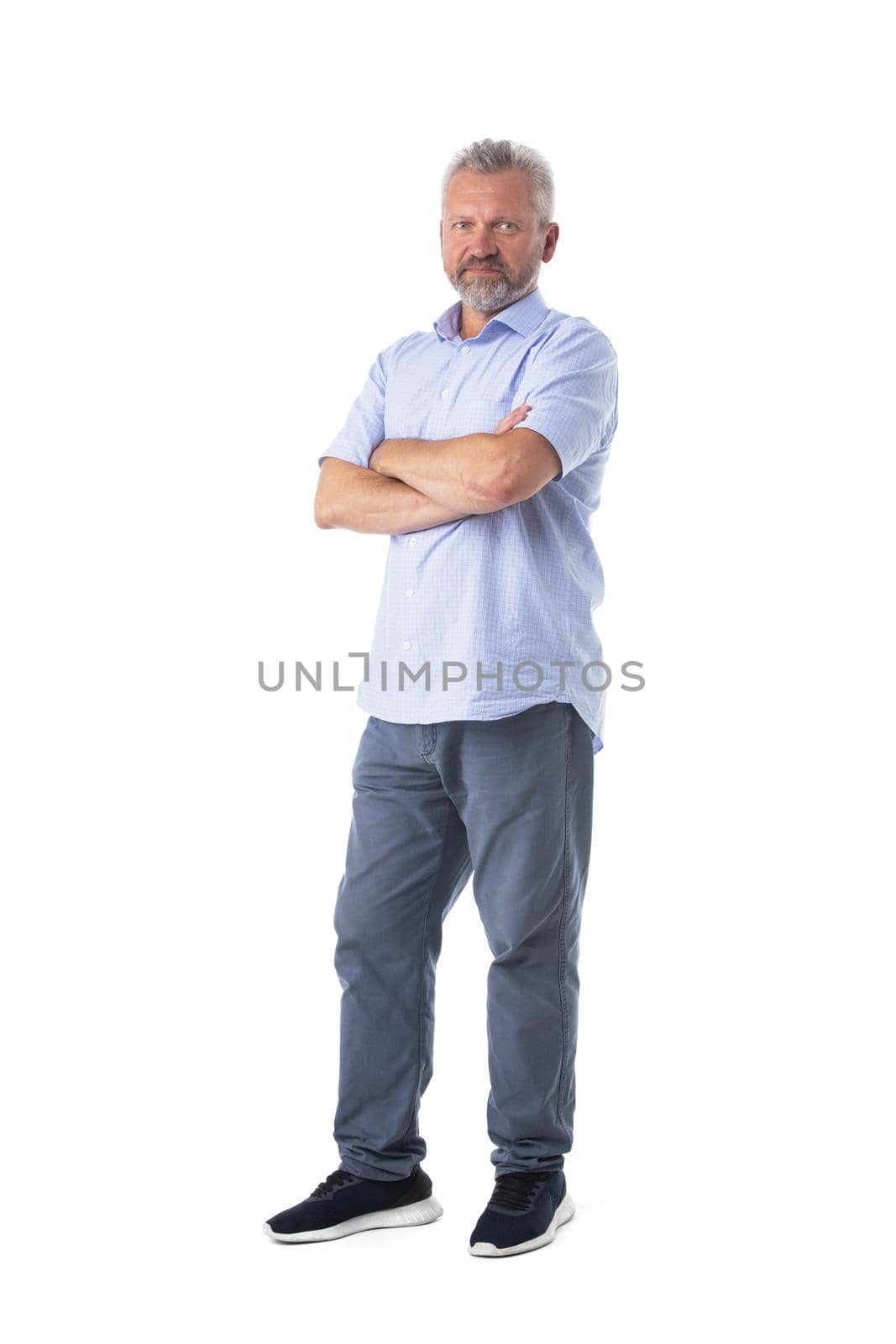 Full length portrait of mature man in casual clothes syanding with arms folded isolated on white background