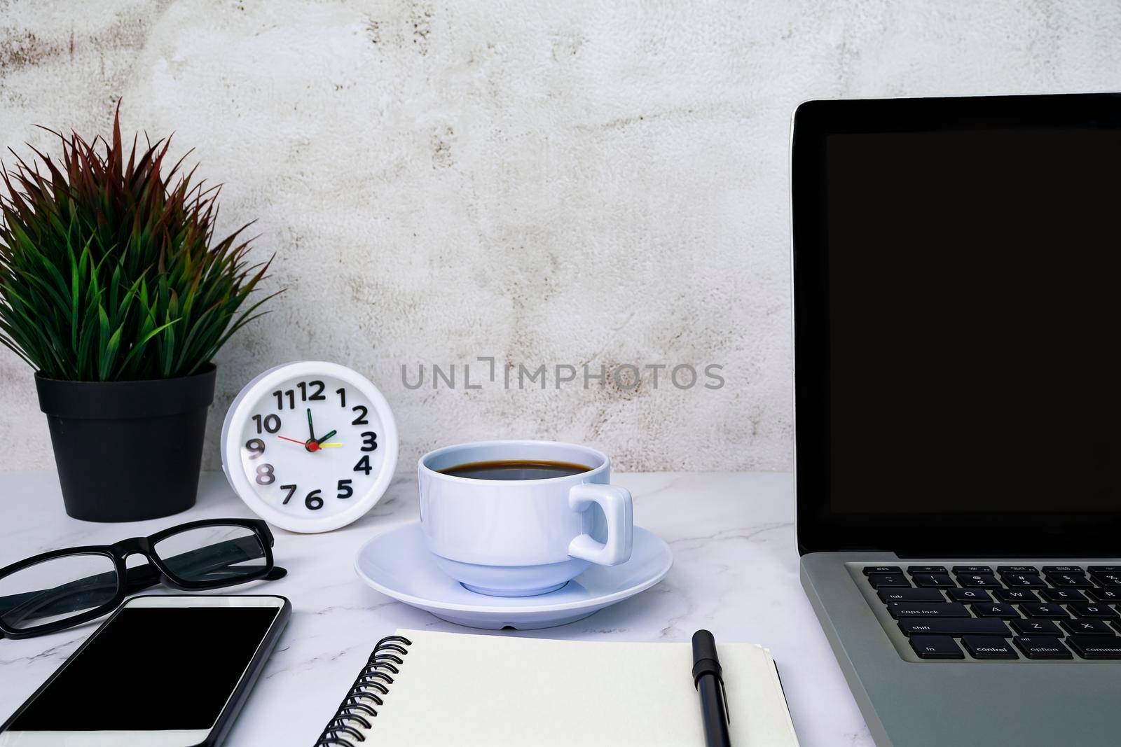 Styled stock photography white office desk table with blank notebook, computer, supplies and coffee cup. Copy space.