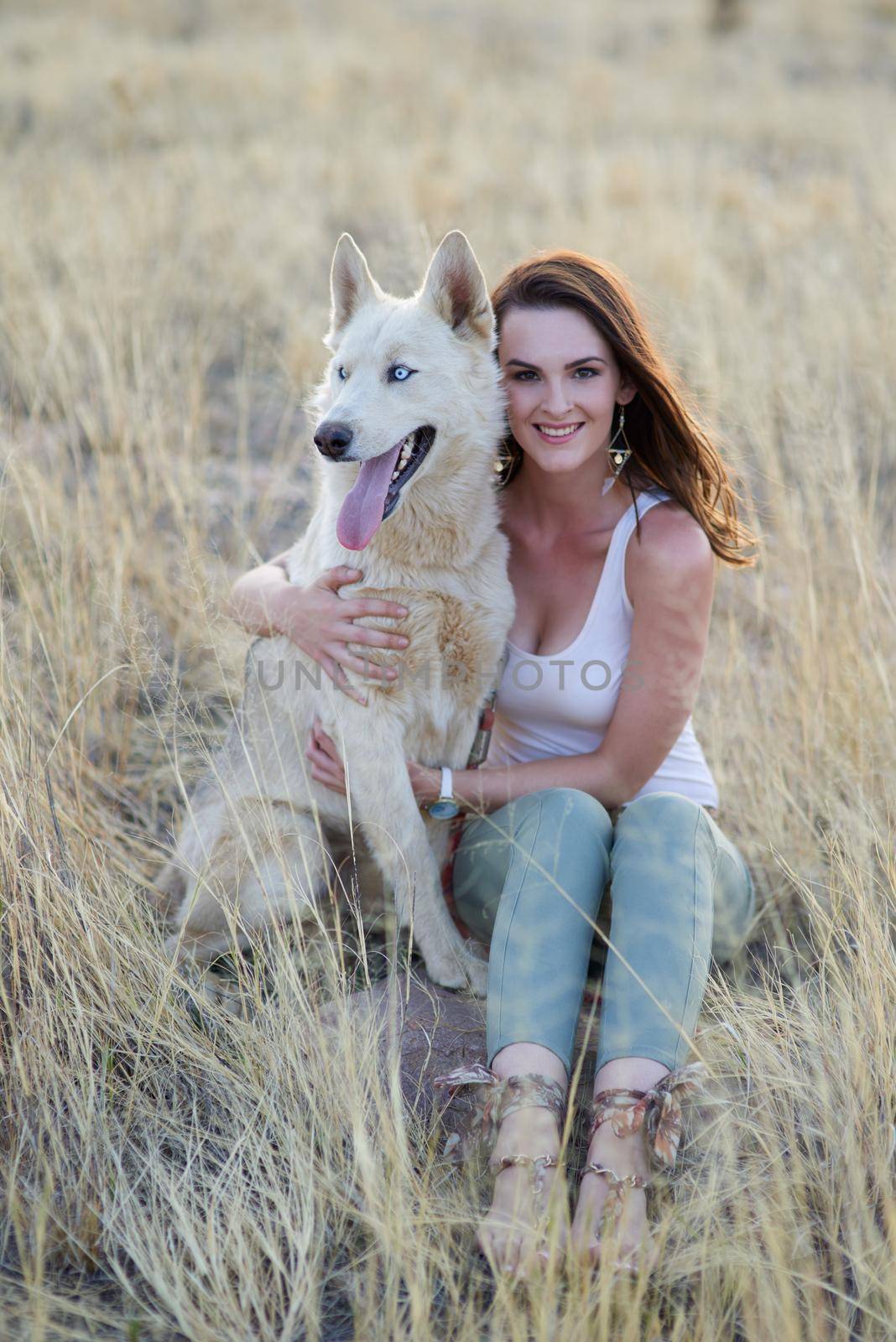 Portrait of an attractive young woman bonding with her dog outdoors.