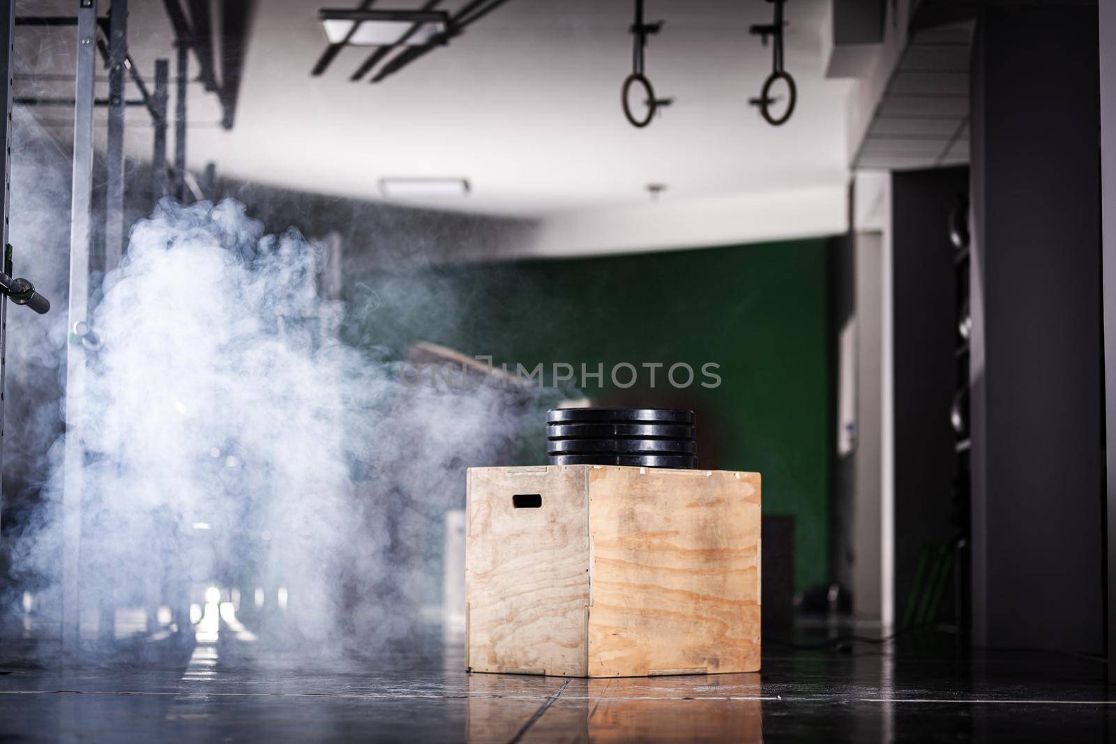 Workout interior with wooden boxes and smoke. Generic fitness studio background. by kokimk