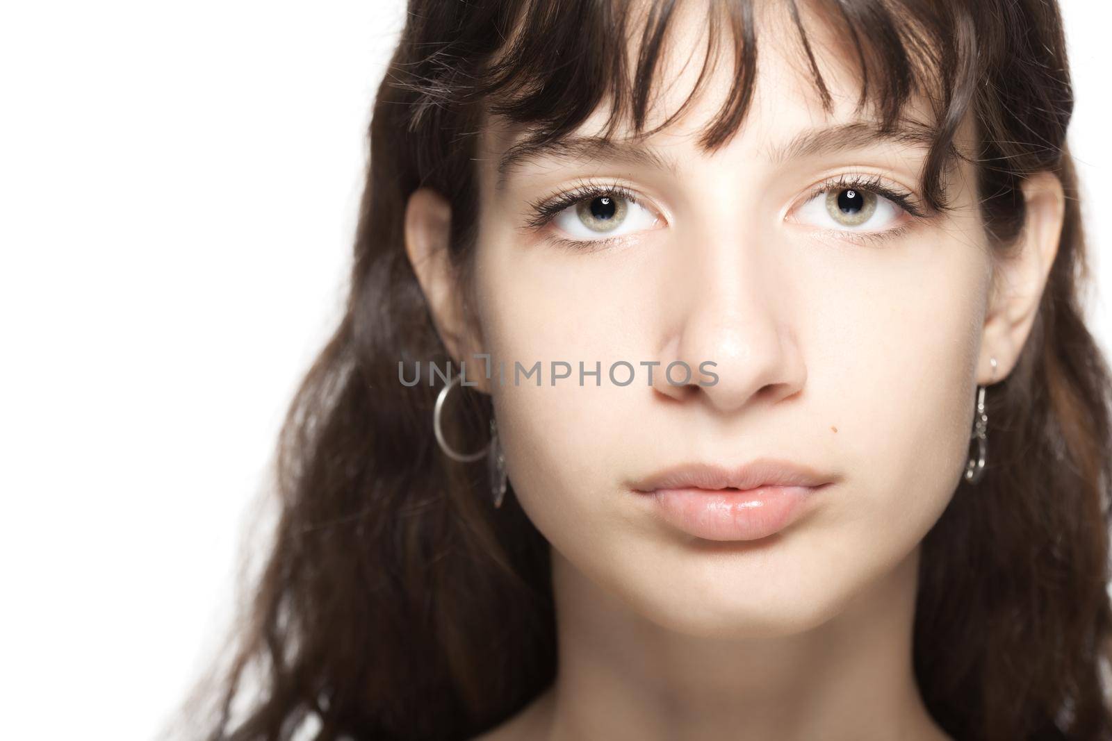 Beautiful young girl studio portrait. Looking at camera. by kokimk