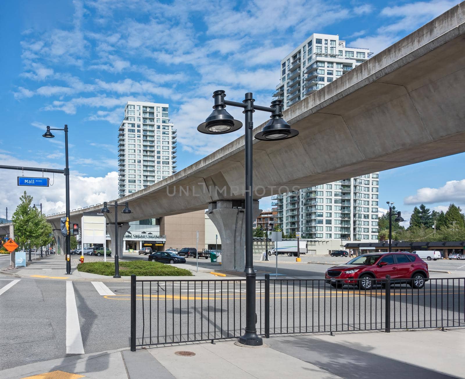 City plaza overview on a bright sunny day. Street view with skytrain line over head