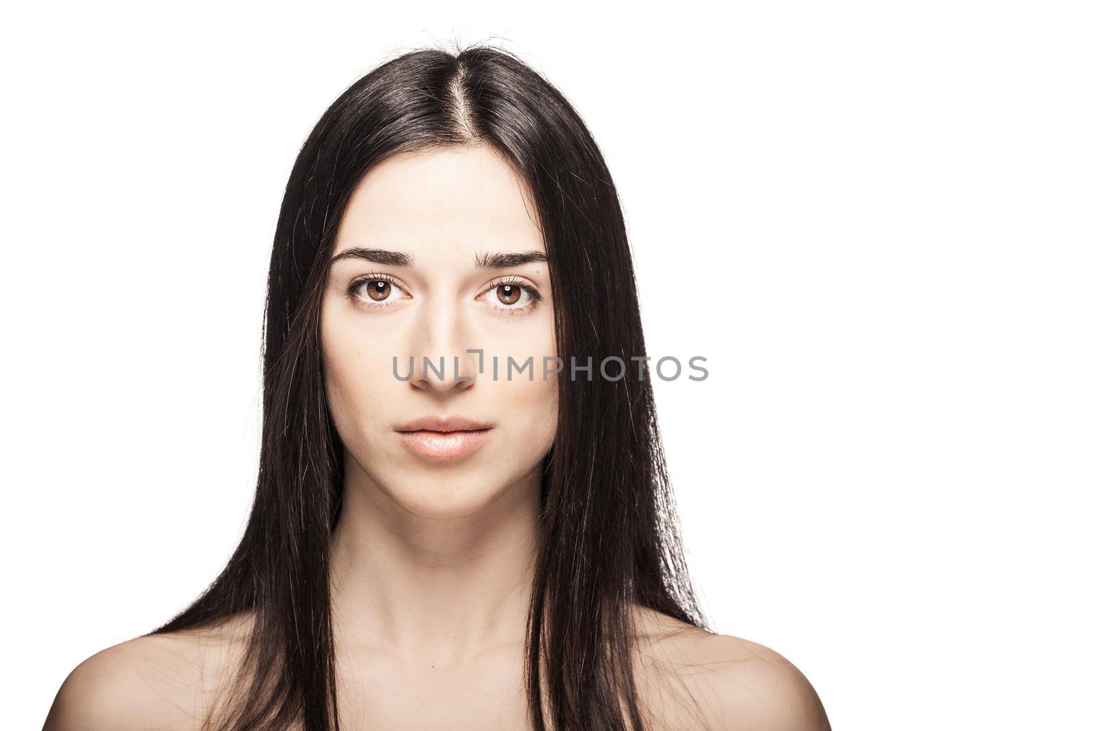 studio portrait of a beautiful young girl against white backgroung. looking at camera.