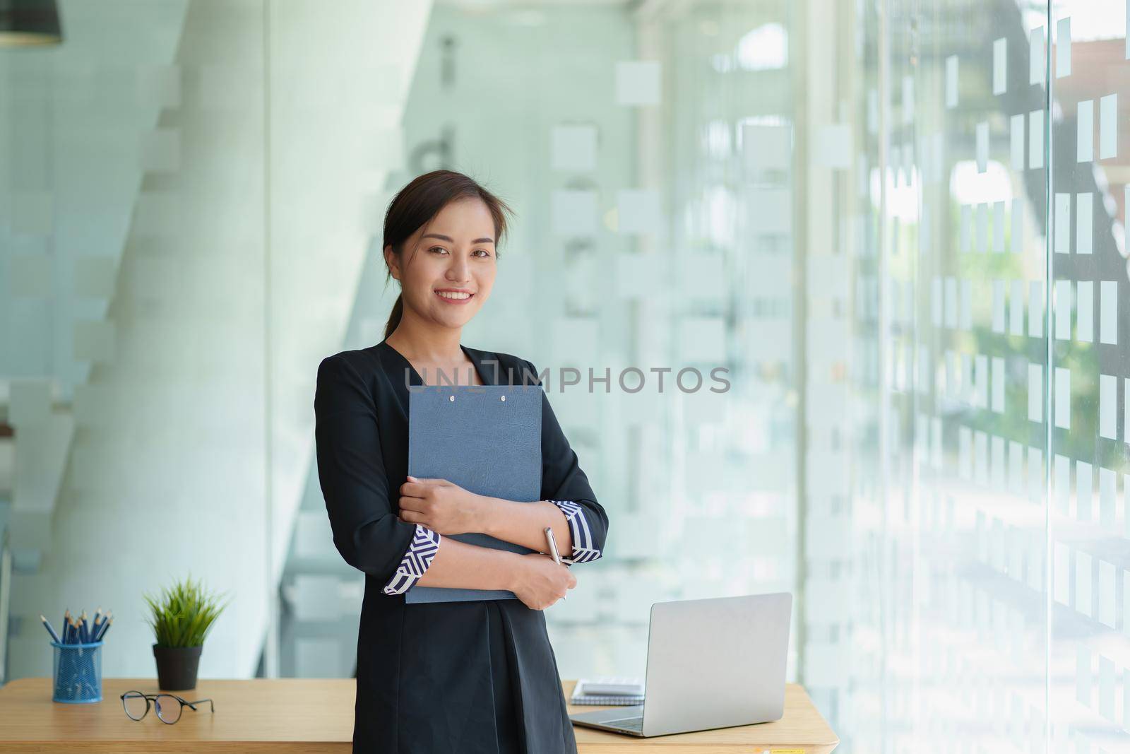 Secretary checking schedule at front of boss room