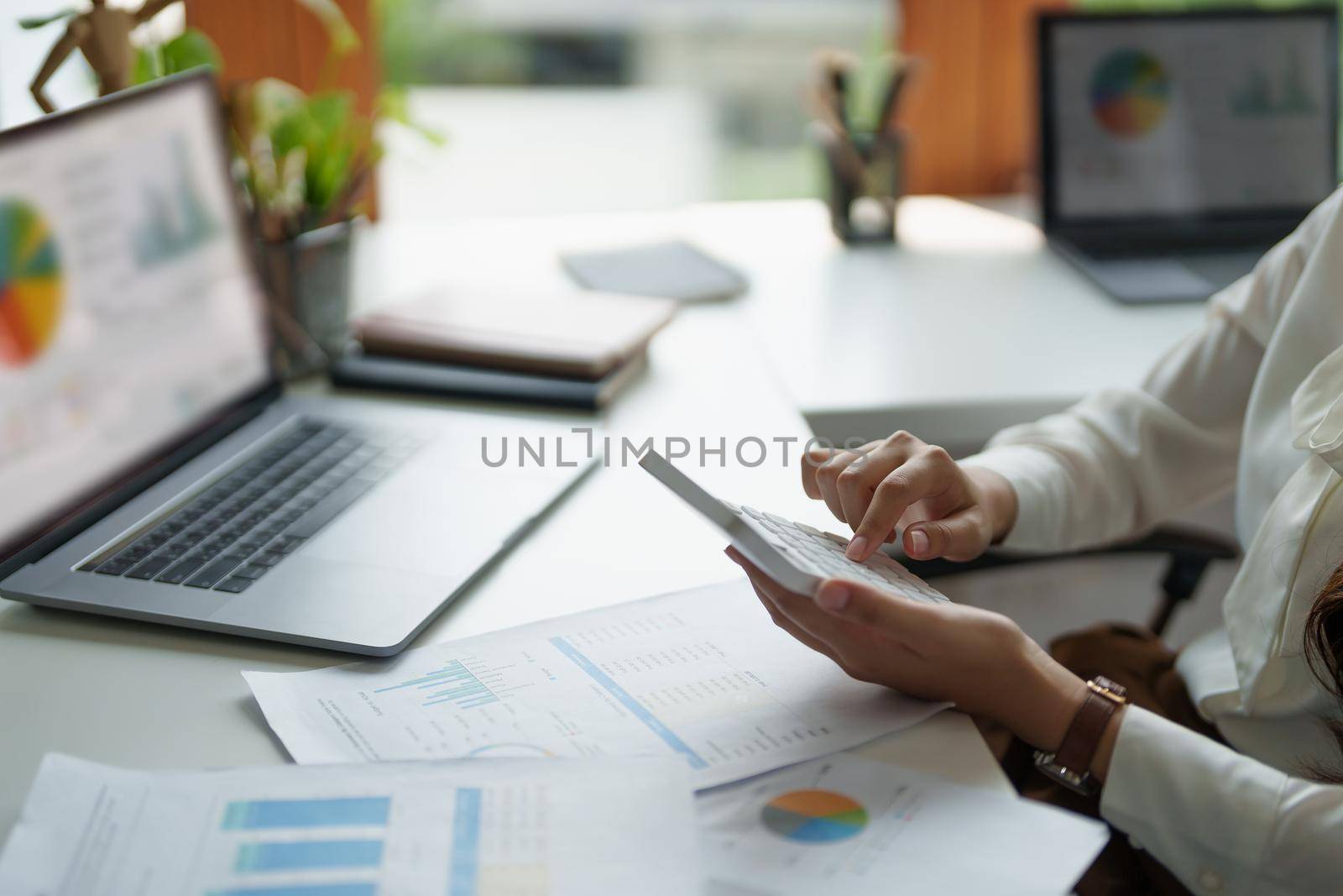 Close up hand of accountant working with computer and calculator for business and financial expense.