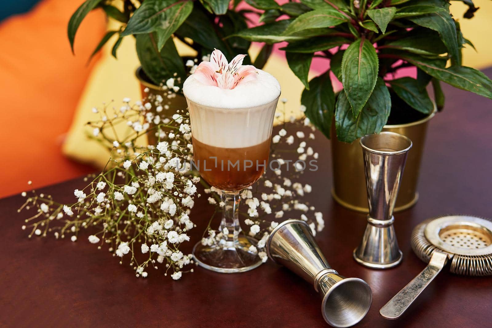 Beautiful cocktail and two flowers on table by wip3out