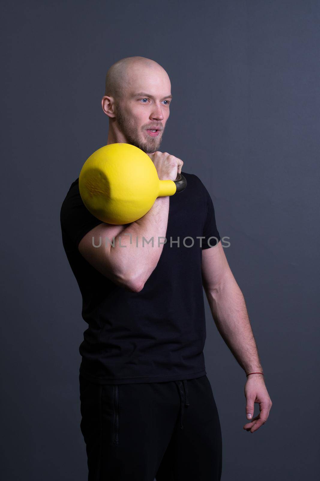 Guy with a yellow kettlebell gym anonymous young strength, for fit lifestyle from strong and up sportswear, asian fitness. Healthy bent health, circuit hiit