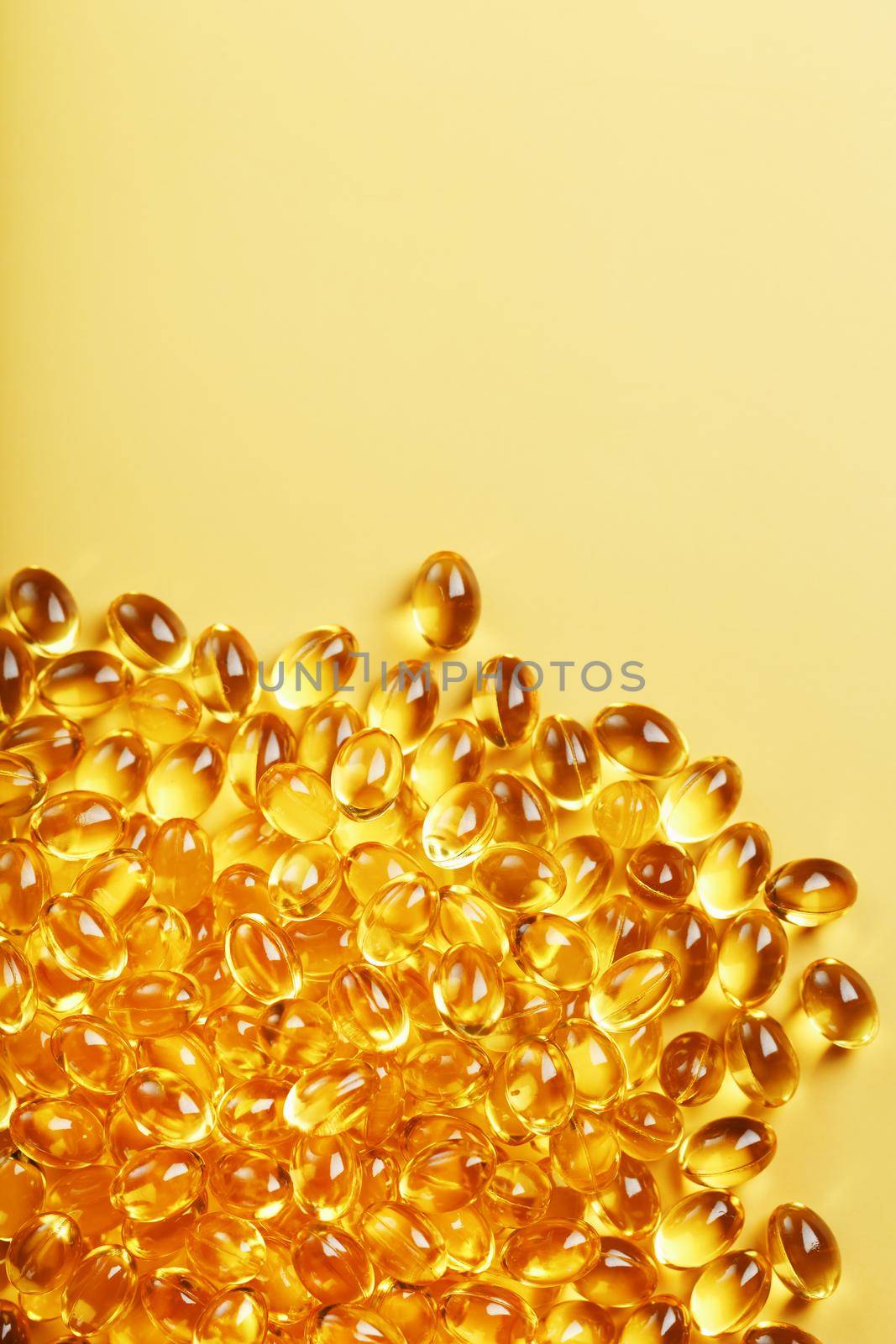 Golden capsules of Vitamin Omega 3 Fish Oil close-up by AlexGrec