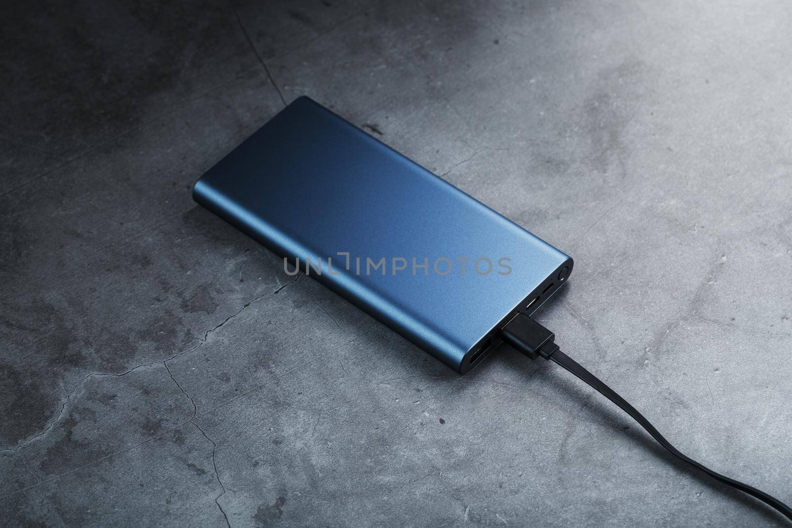 Battery Power supply for recharging gadgets and electronic devices on a dark background