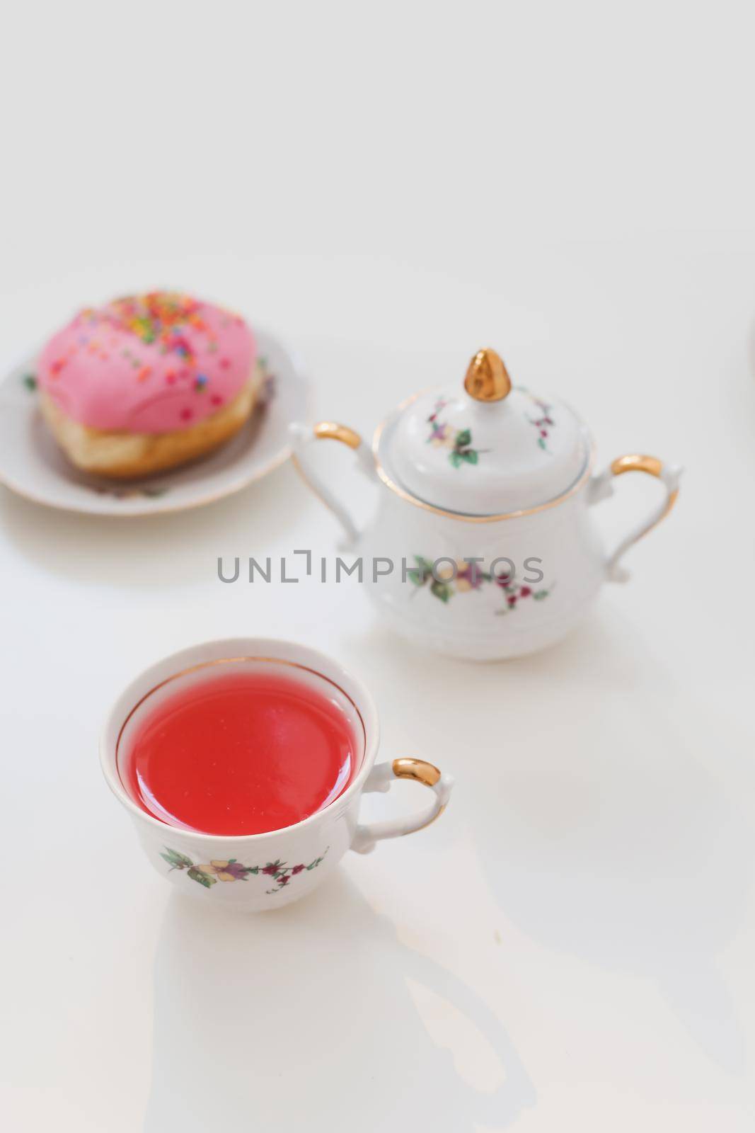 morning breakfast with colorful pink drink and donuts on white table. holiday, birthday party composition, flatlay top view. 