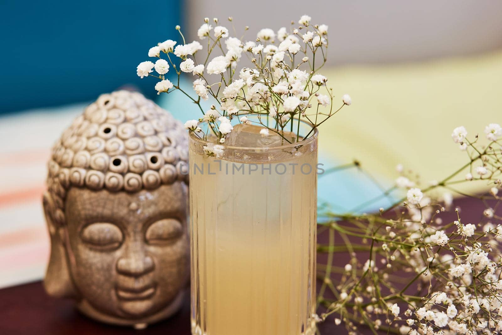 Beautiful cold cocktail and flowers on table by wip3out