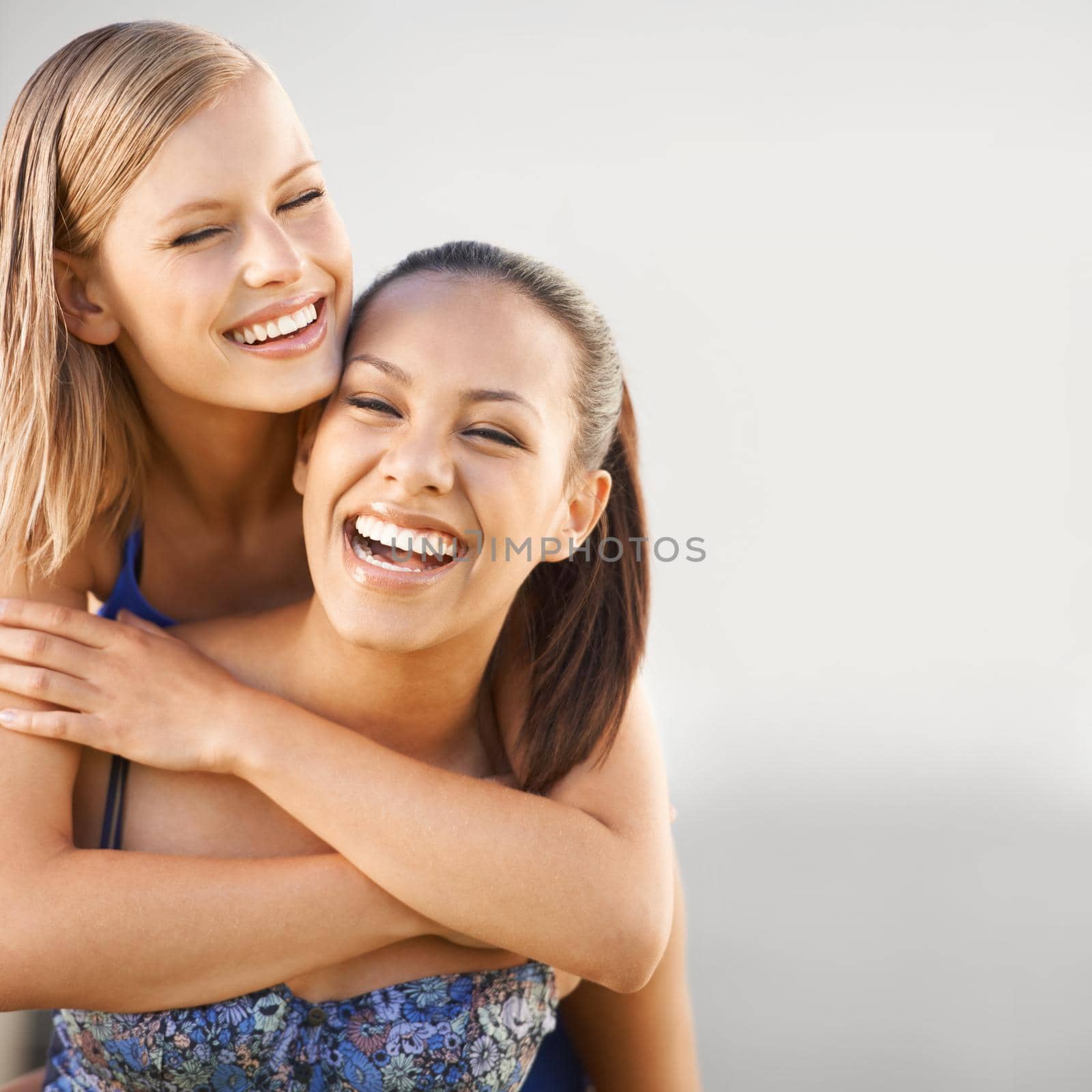 A young woman enjoying a hug from her best friend.