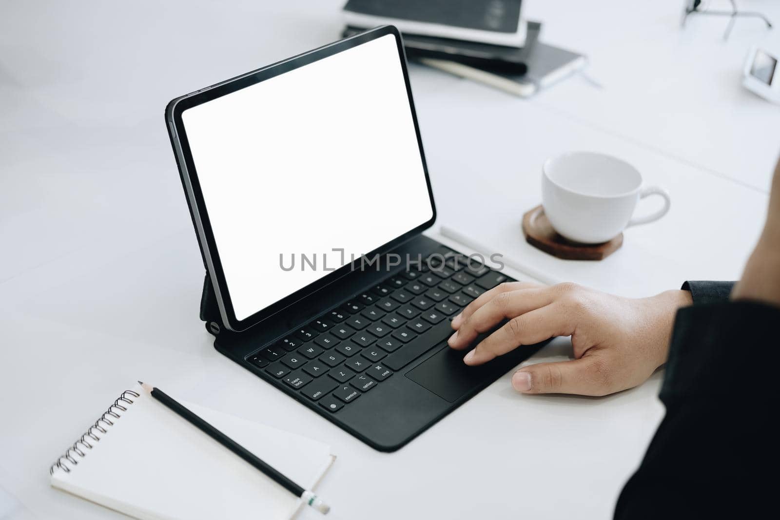 Young man using work from home tablet at work, the blank space on the computer screen can insert text