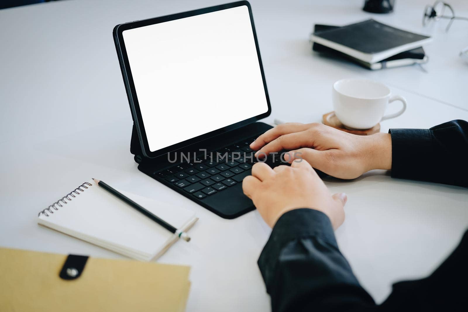 Young man using work from home tablet at work, the blank space on the computer screen can insert text