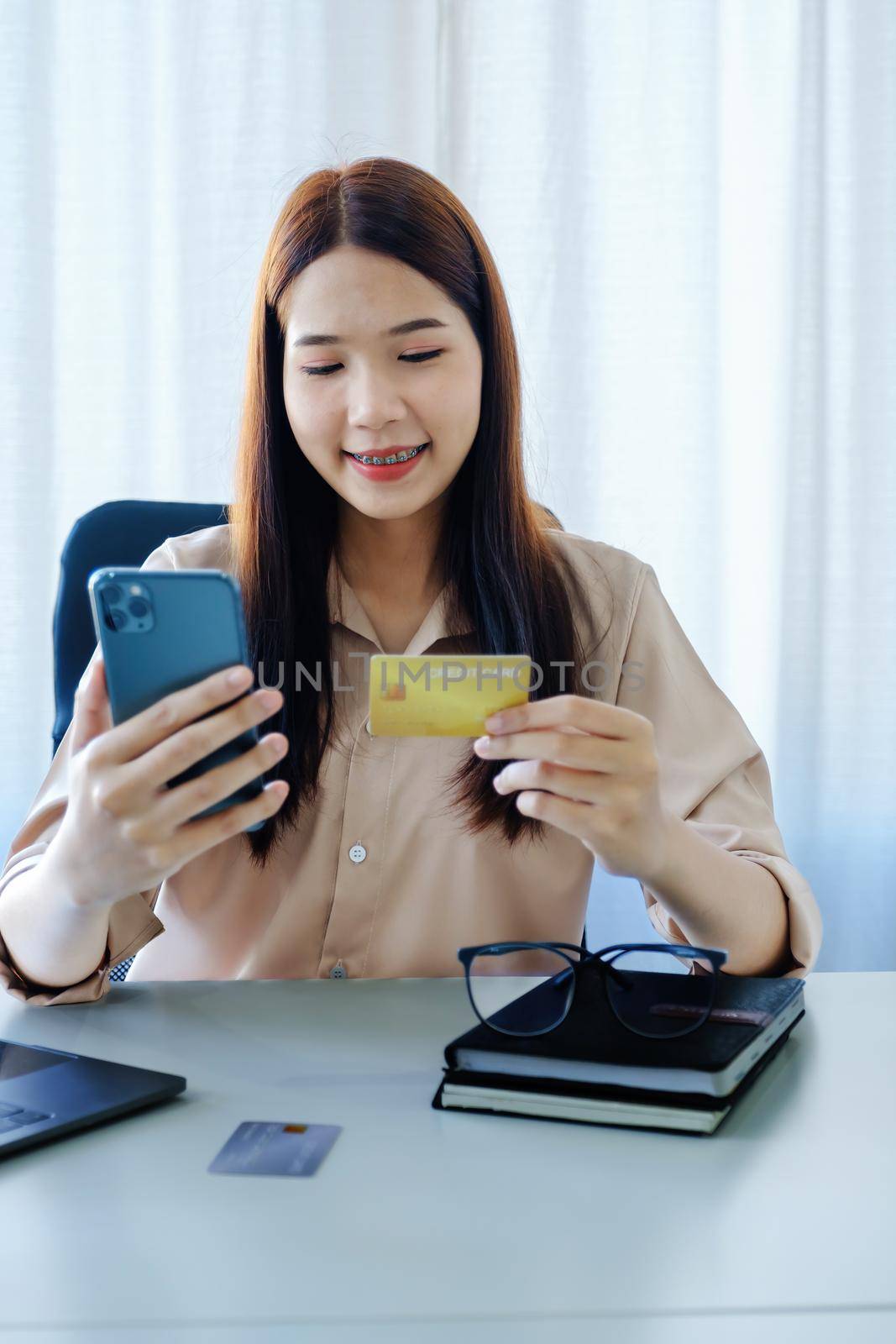 Online Shopping and Internet Payments, Beautiful Asian women are using their credit cards and mobile phones to shop online or conduct errands in the digital world. by Manastrong