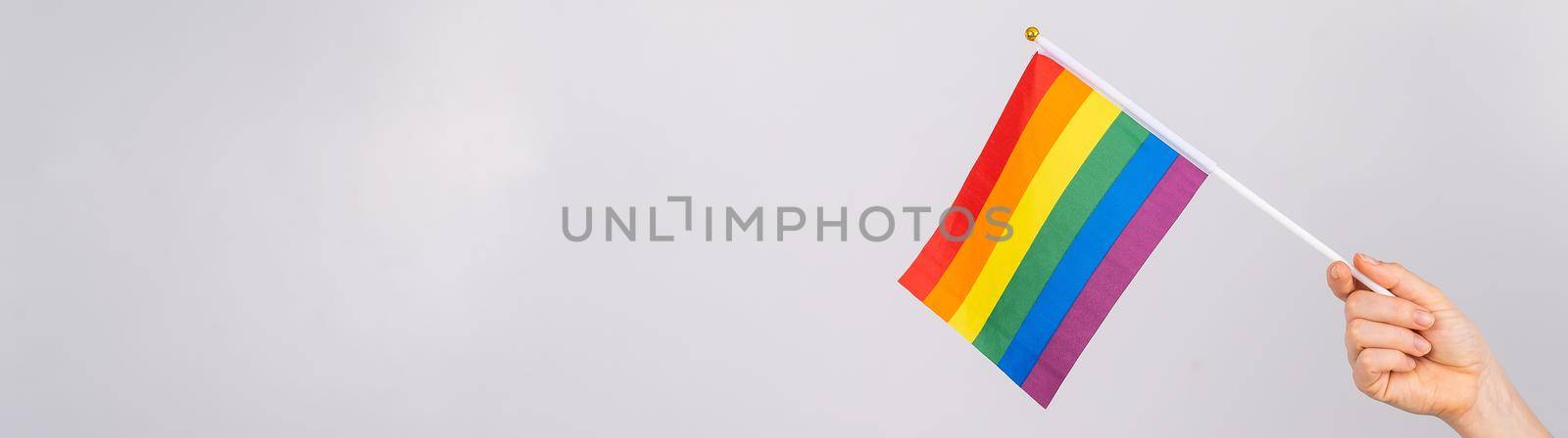 A woman is holding a rainbow flag on a white background. by mrwed54