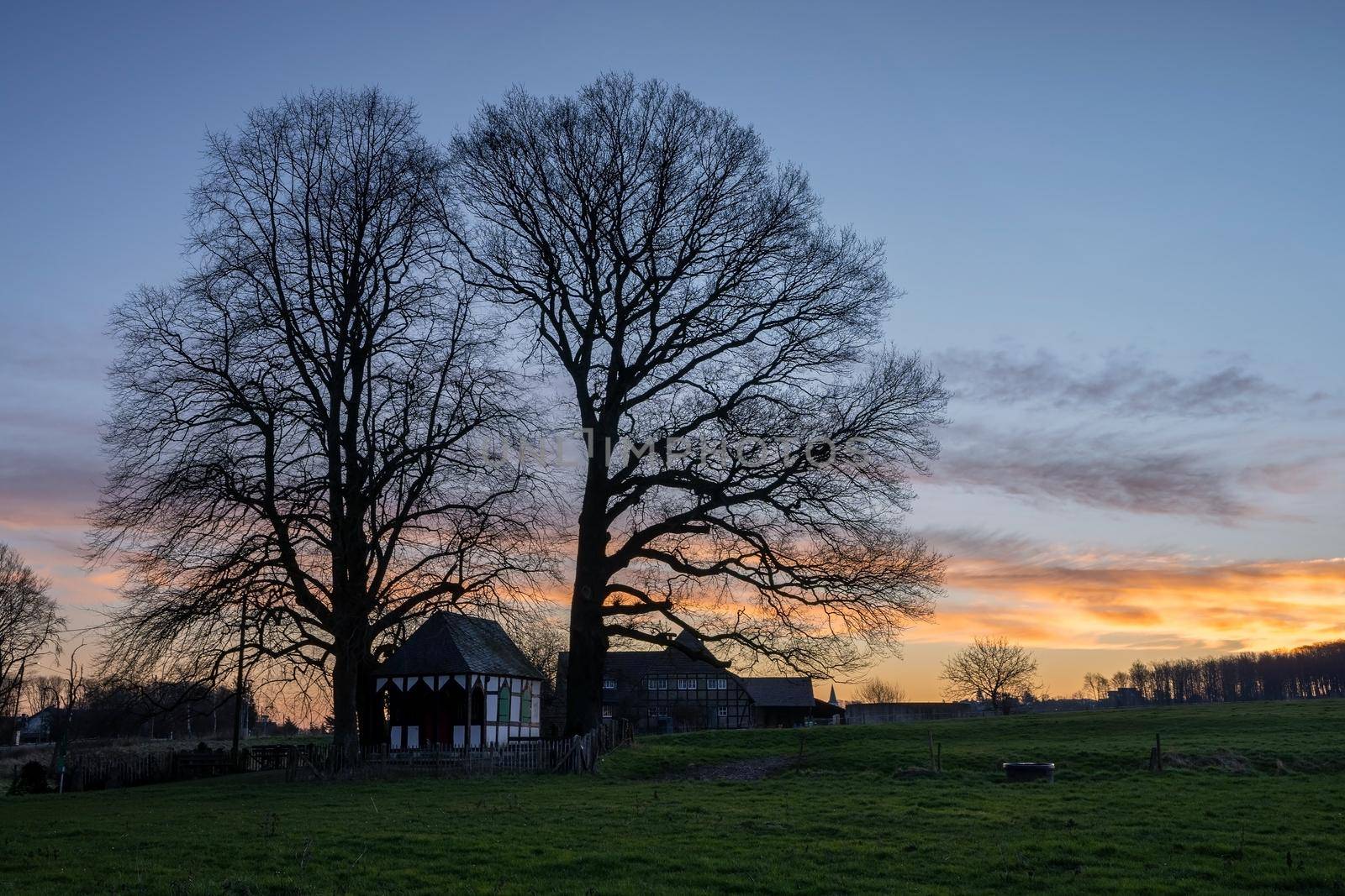 Panoramic image of small chapel under trees during sunrise, Bergisch Gladbach, Germany