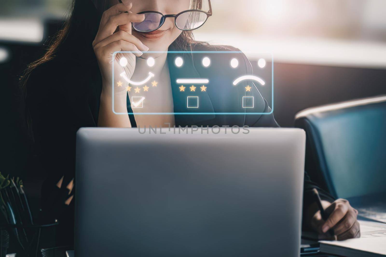 Quality and Satisfaction Rating Concept, Assessment, smiling businesswoman using laptop computer to answer surveys and assess 5-star satisfaction