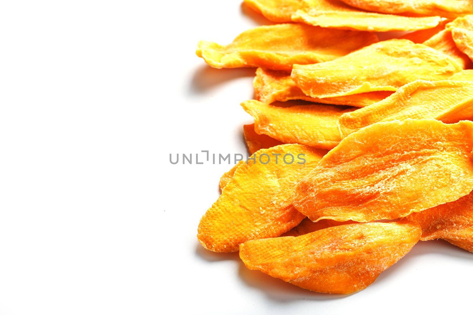Ripe dried mango sliced on a white background with free space