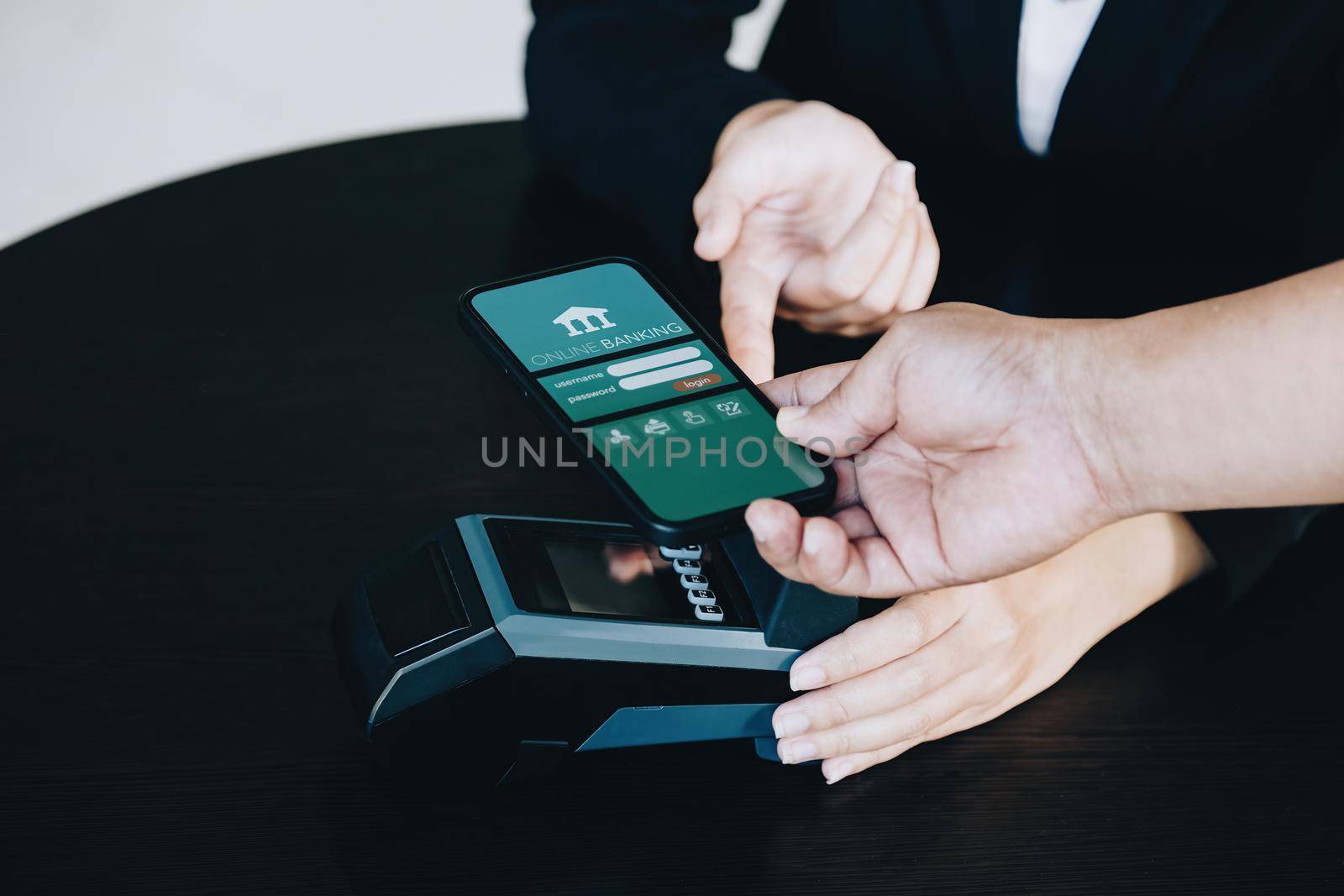 Payment security technology concept and service fees, Employees are holding electronic card machines for customers to use smartphone mobile to pay via paywave technology. by Manastrong