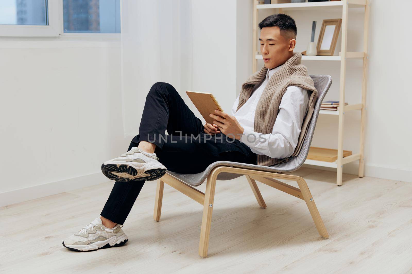teenager with a tablet sits in a chair communication Lifestyle. High quality photo
