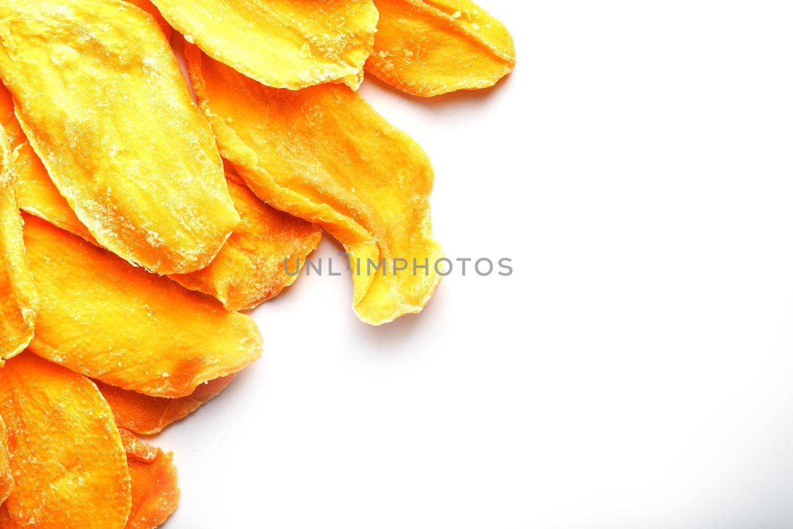 Ripe dried mango sliced on a white background with free space
