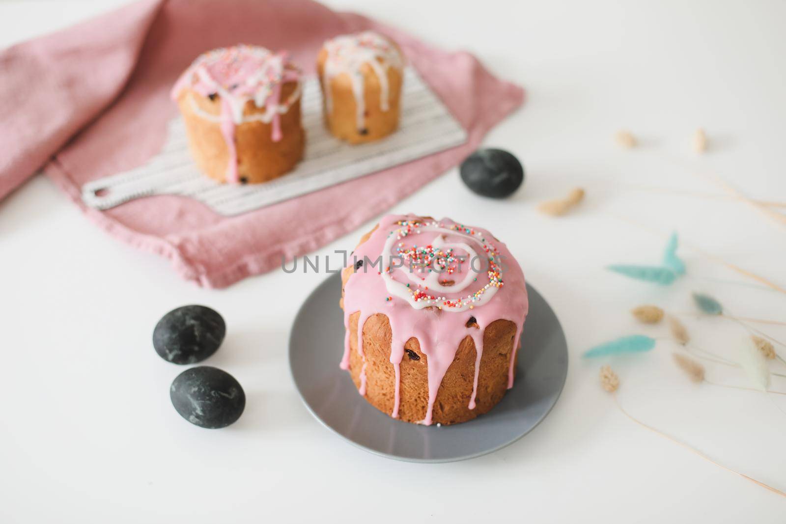 Easter cake, colorful eggs and willow branches on light background. Happy Easter holiday concept. festive spring season.