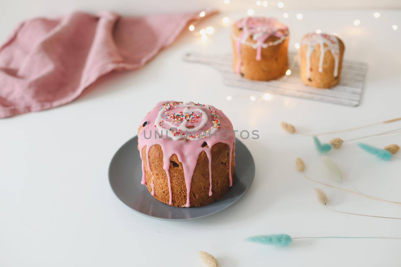 Easter cake, colorful eggs and willow branches on light background. Happy Easter holiday concept. festive spring season.