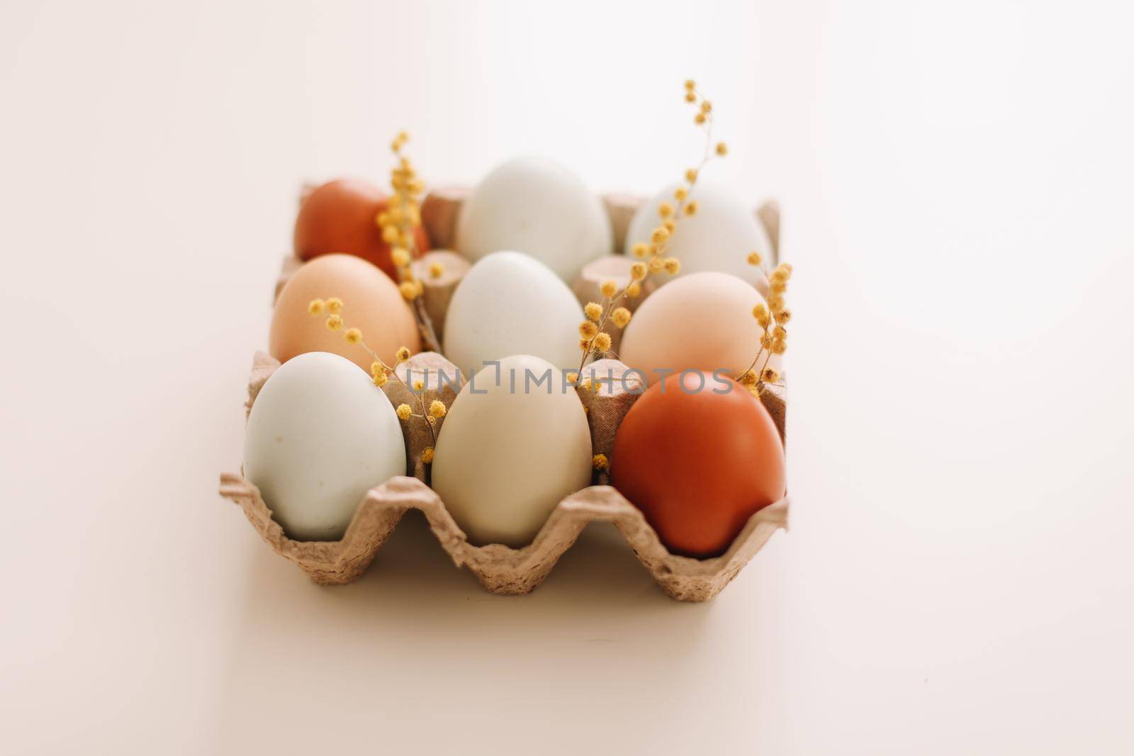 Chicken eggs of natural shades and colors on a white background. Healthy organic food, natural farmer's products concept. Happy Easter background. Selective focus. 