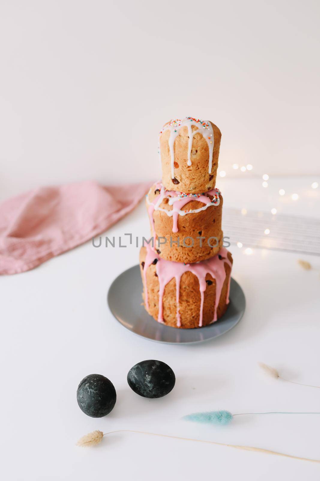 Easter cake, colorful eggs and willow branches on light background. Happy Easter holiday concept. festive spring season.