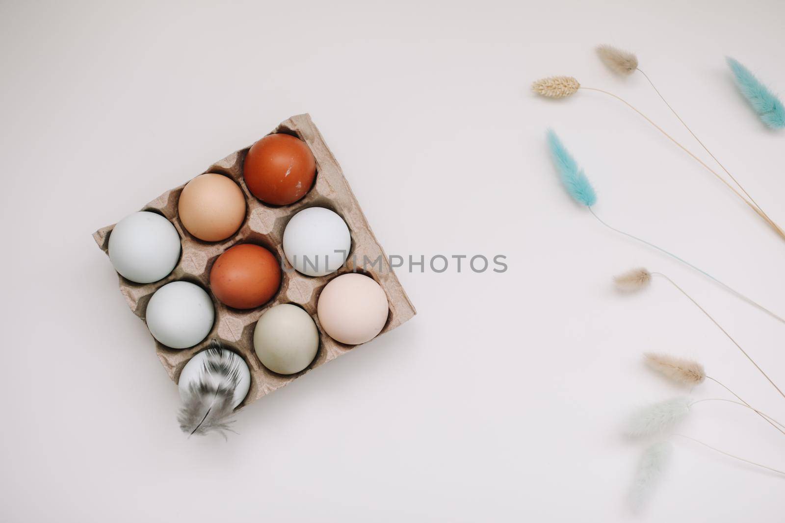 Chicken eggs of natural shades and colors on a white background. Healthy organic food, natural farmer's products concept. Happy Easter background. Selective focus. 