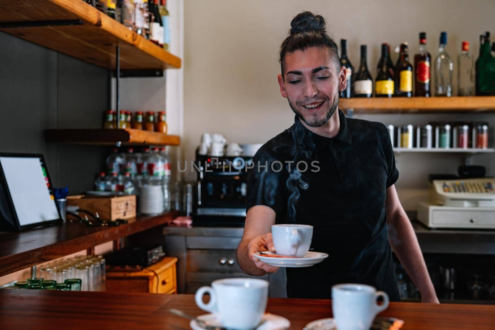 Waiter serving cups of coffee at the bar counter. counter bar with two coffee cups. . Cups of coffee steaming. by CatPhotography