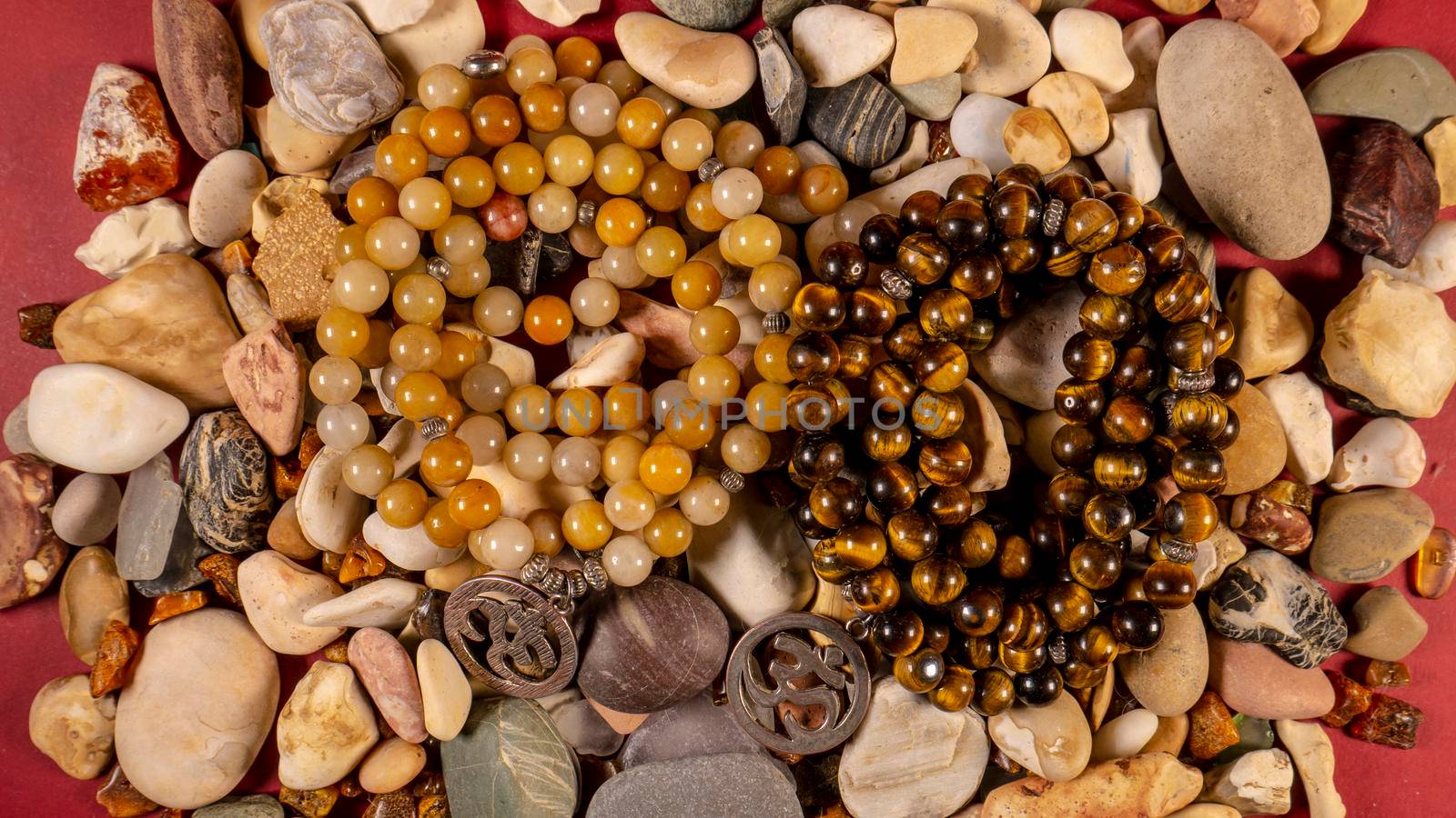 Buddhist prayer beads Mala lying on the sea rocks. the view from the top. the General plan. color by lempro