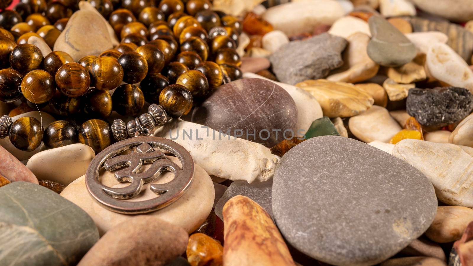 Buddhist prayer beads Mala lying on the sea rocks. close-up by lempro