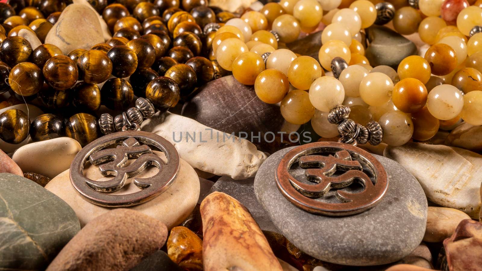 Buddhist prayer beads Mala lying on the sea rocks. close-up color