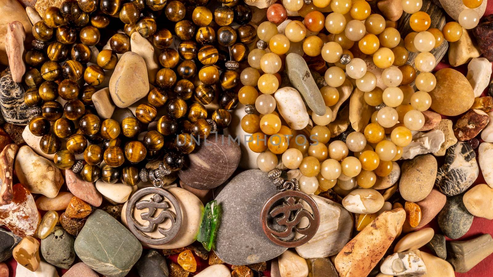 Buddhist prayer beads Mala lying on the sea rocks. the view from the top. the General plan. color by lempro