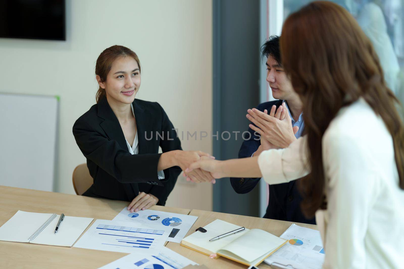 Business asian people shaking hands, finishing up meeting, business etiquette, congratulation, merger and acquisition concept by nateemee