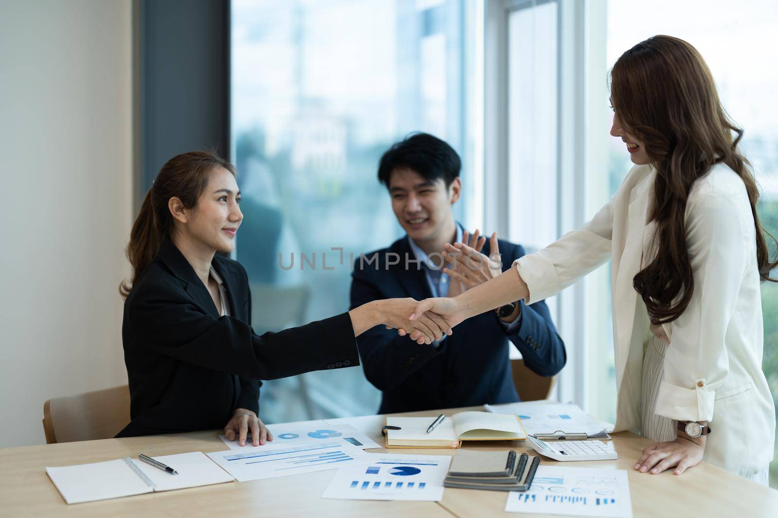 Business asian people shaking hands, finishing up meeting, business etiquette, congratulation, merger and acquisition concept by nateemee