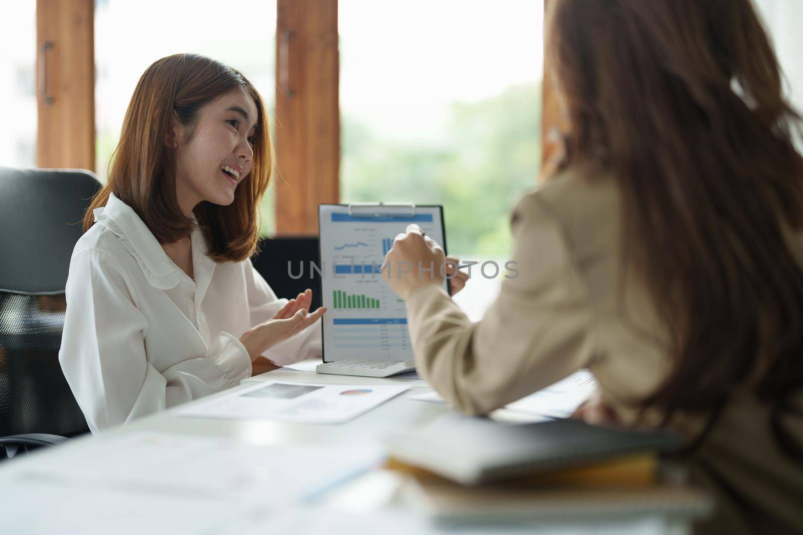 Asian business adviser meeting to analyze and discuss the situation on the financial report in the meeting room.Investment Consultant, Financial advisor and accounting concept.